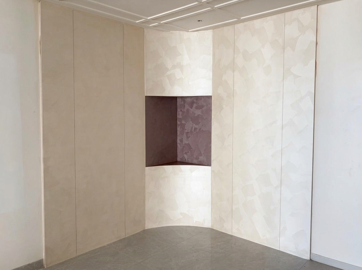 Cream geometric plaster panels surrounding a muted mauve recessed niche