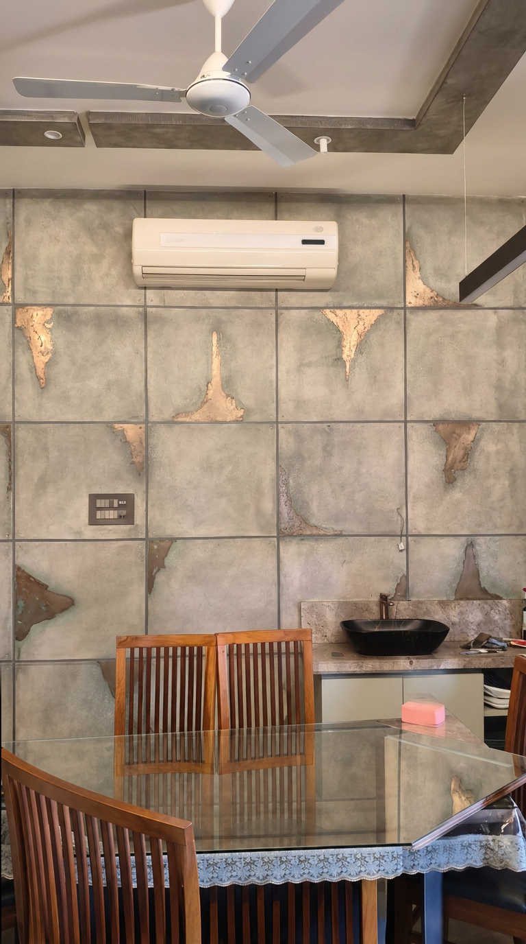 Dining area with grey decorative wall panels and irregular metallic accents